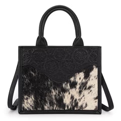 Black hair-on cowhide tote with floral tooled leather and round handles