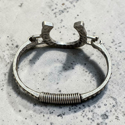 Silver horseshoe embellished open cuff bangle with black accents BACK VIEW
