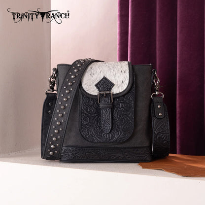 Trinity Creek floral tooled cowhide bag with studded crossbody strap