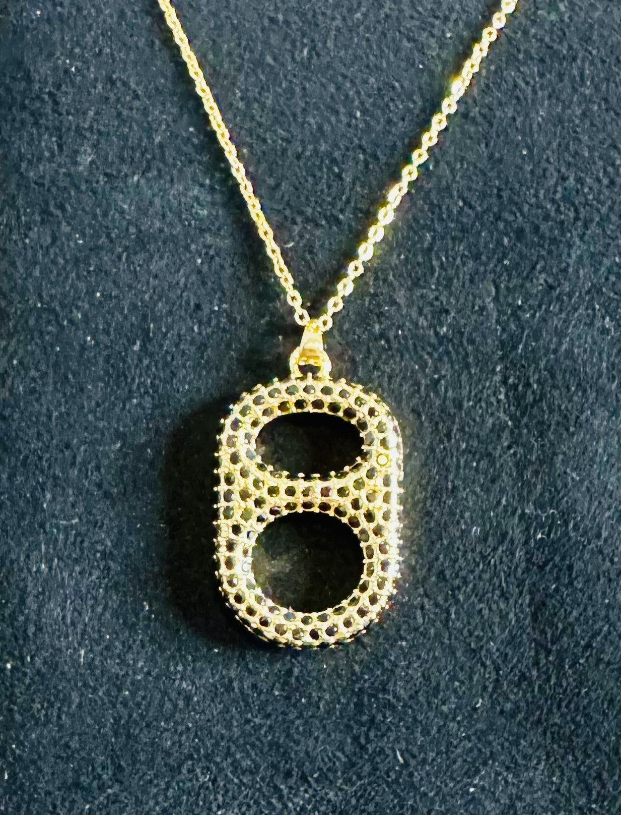 Close up blackout luxe pop tab pendant necklace gold and black rhinestones