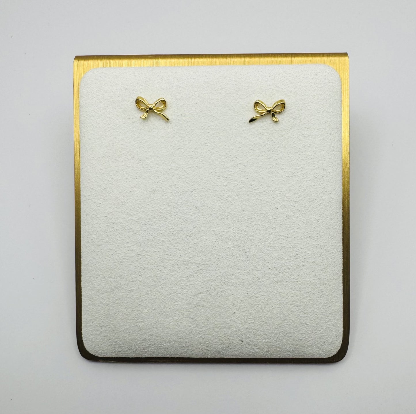 Dainty brass bow stud earrings in gold or silver with silicone backs – hypoallergenic, lightweight, and perfect for gifting