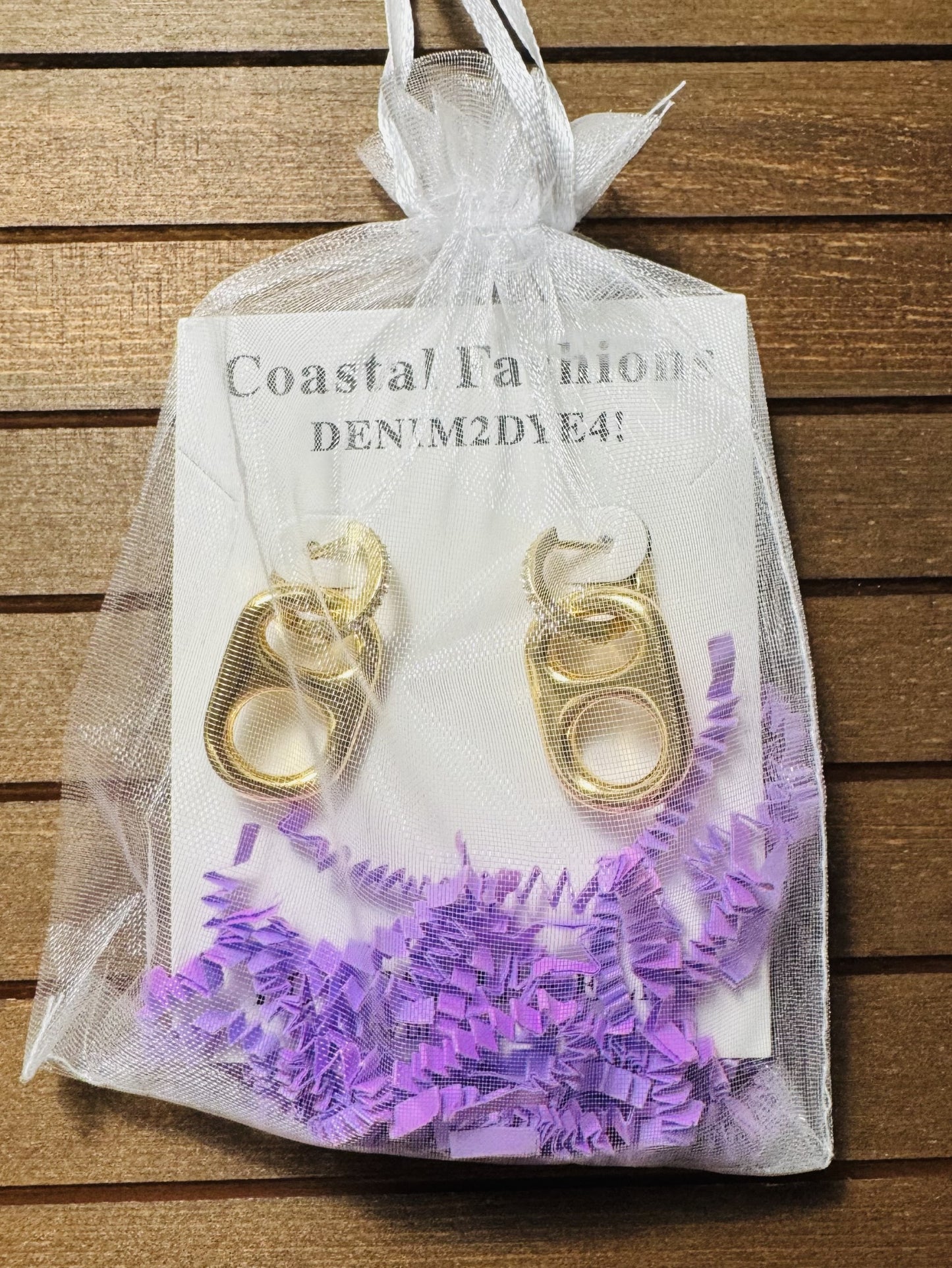 sun kissed gold pop tab charm in jewelry bag packaging
