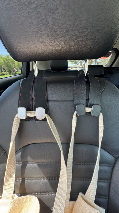 The Purse Perch™ organizing groceries and shopping bags behind a vehicle seat.