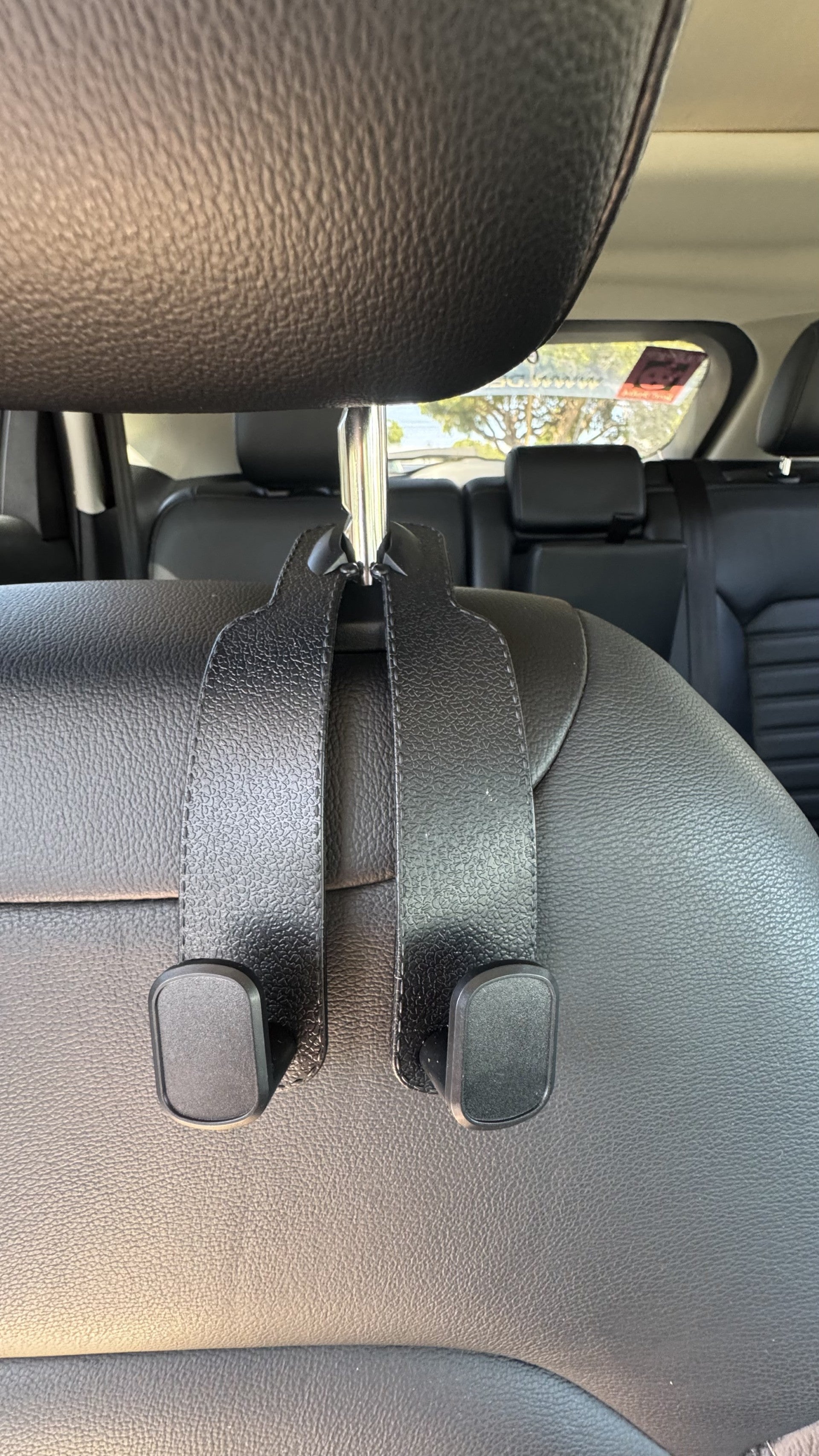 Black The Purse Perch™ multifunction headrest hook with aluminum alloy frame.